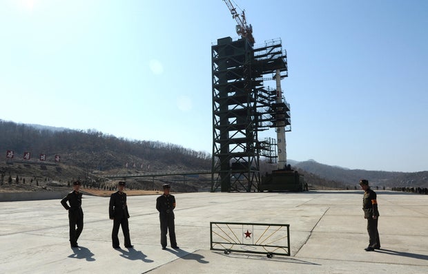 North Korea apparently launches missile into sea after announcing plan to put rocket into orbit with spy satellite
